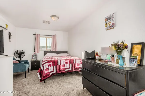 a bedroom with a bed and dresser