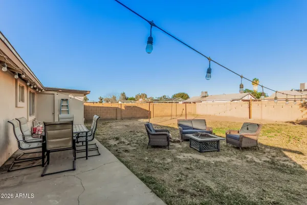 a roof deck with table and chairs