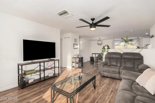 a living room with furniture and a flat screen tv