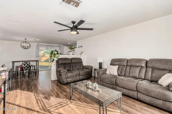 a living room with furniture and a wooden floor