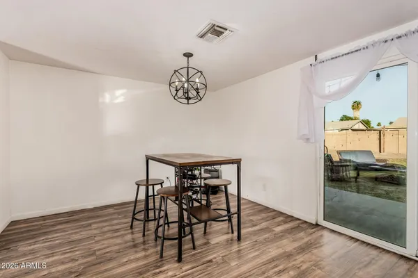 a view of a dining area with furniture and wooden floor