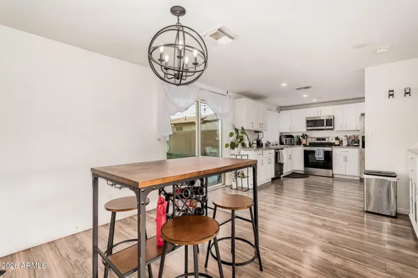 a view of a dining room with furniture wooden floor and a chandelier