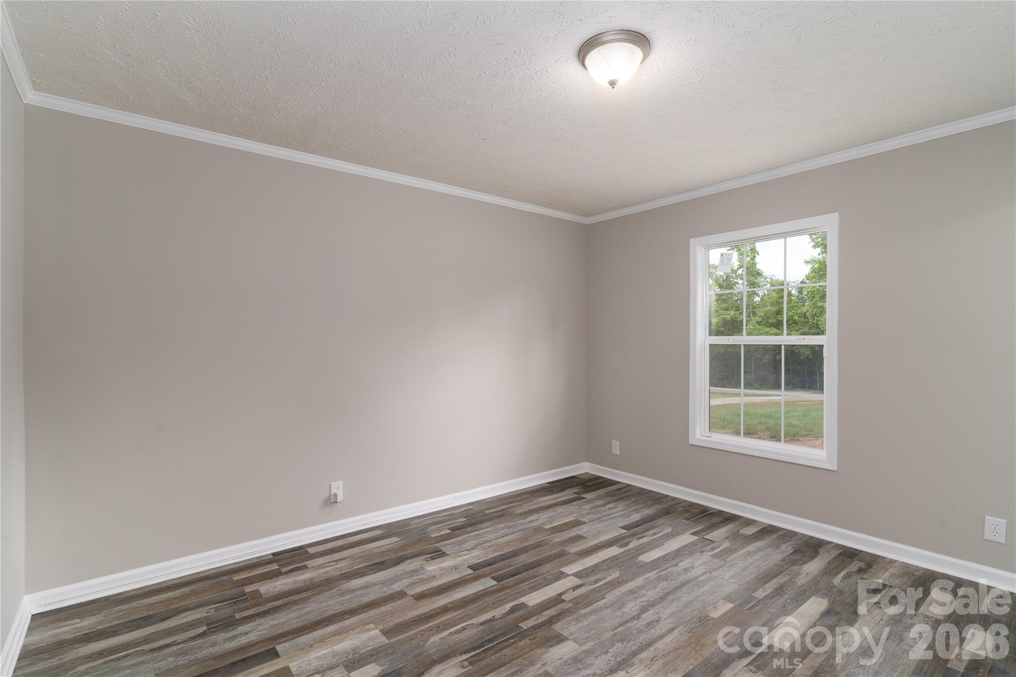 922 Lavender Road Grover, NC 28073 - Photo 27 of 43 an empty room with wooden floor and windows