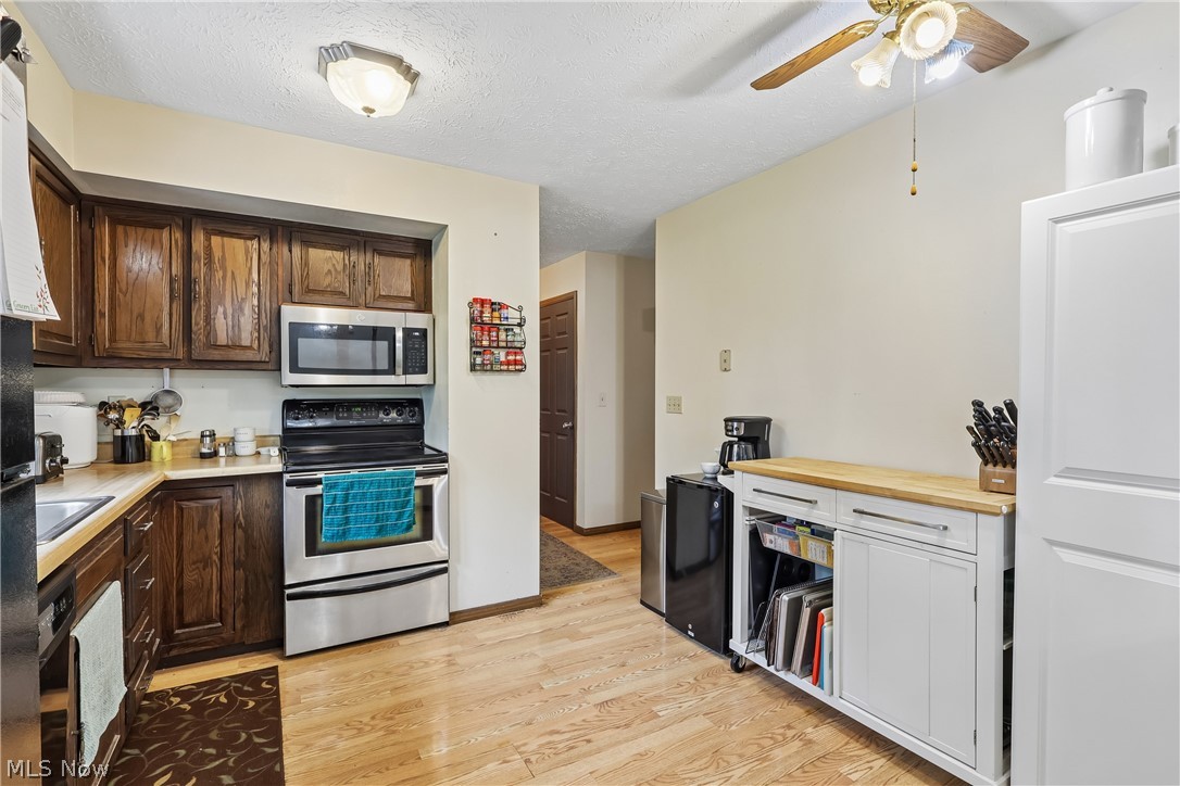 4702 Alger Road Richfield, OH 44286 - Photo 15 of 46 Kitchen with ceiling fan / light, sink, cabinets, dishwasher, stove and refrigerator
