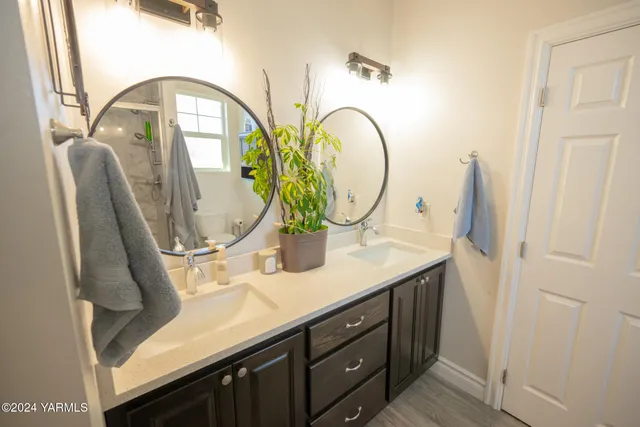 a bathroom with a granite countertop sink a mirror and vanity