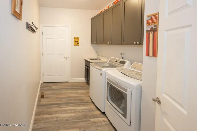 a view of a storage and utility room with washer and dryer