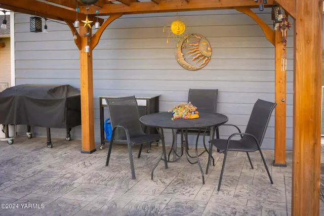a view of a chairs and table in patio