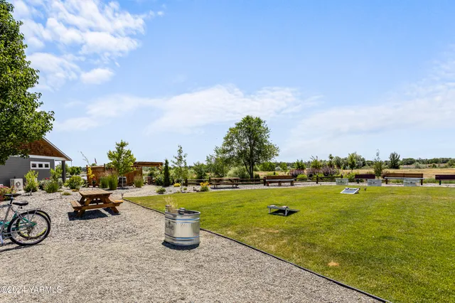 a view of a lake with a yard and car parked