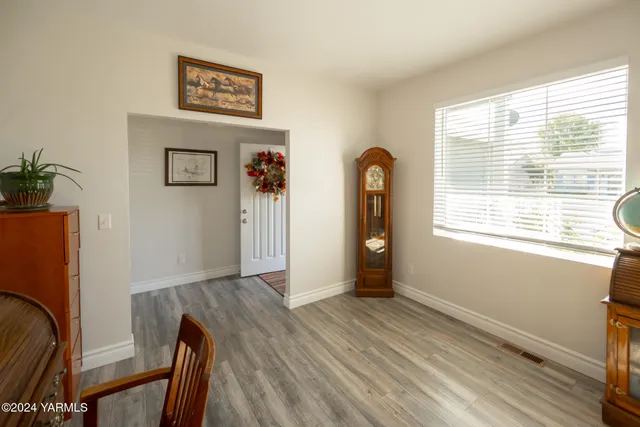 a view of a room with wooden floor and a window