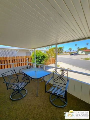 a living room with furniture a rug and a table