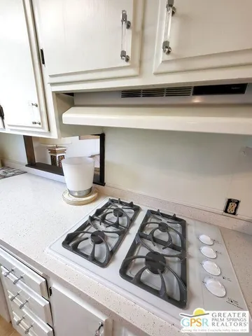 a kitchen with a stove and a microwave