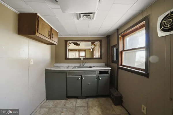 a spacious bathroom with a granite countertop sink and a window
