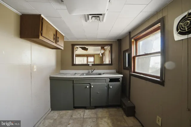 a spacious bathroom with a granite countertop sink and a window
