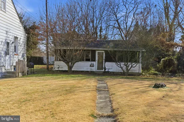 a view of a house with large trees