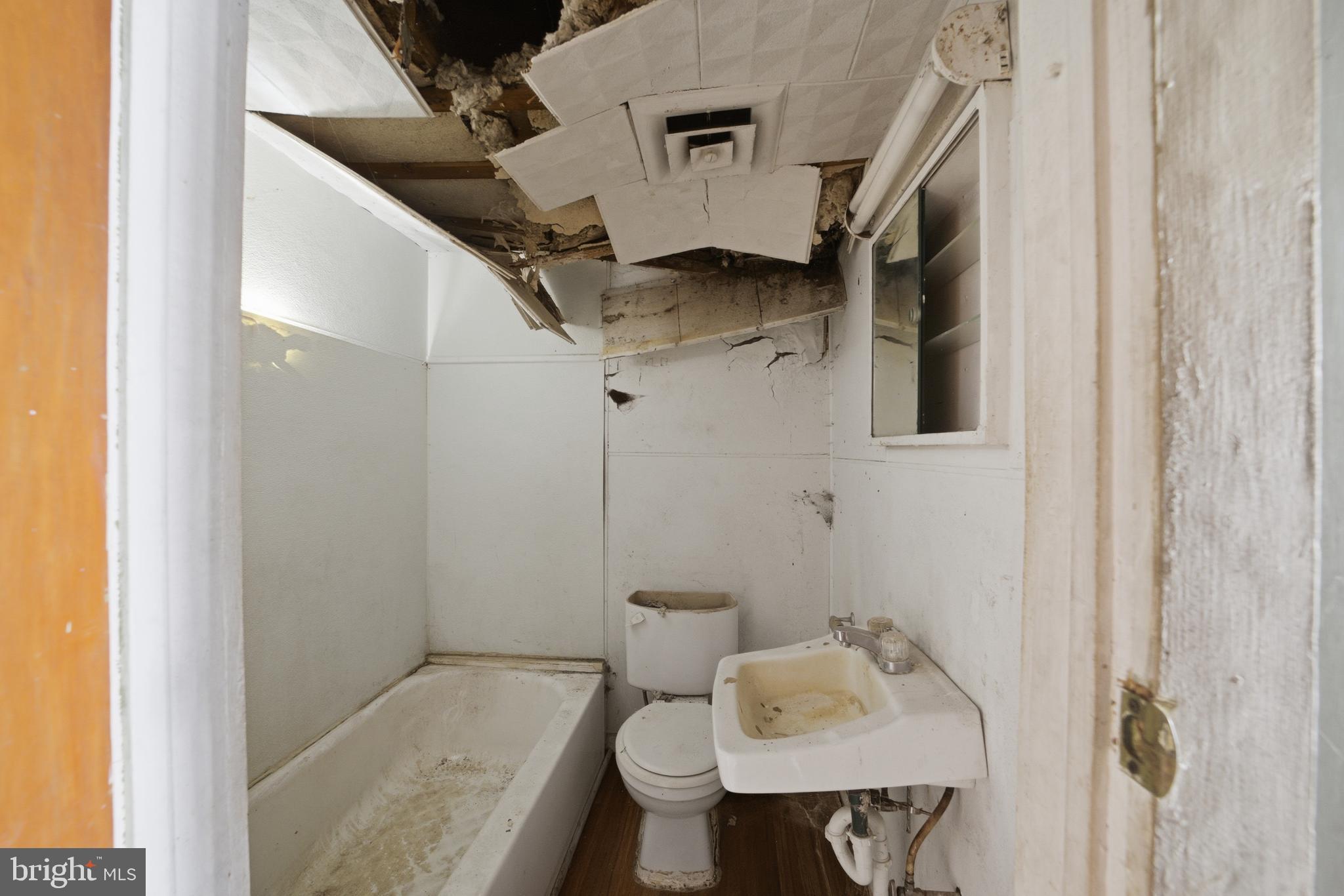 24 Elm Street Salem, NJ 08079 - Photo 8 of 28 a bathroom with a sink toilet and shower