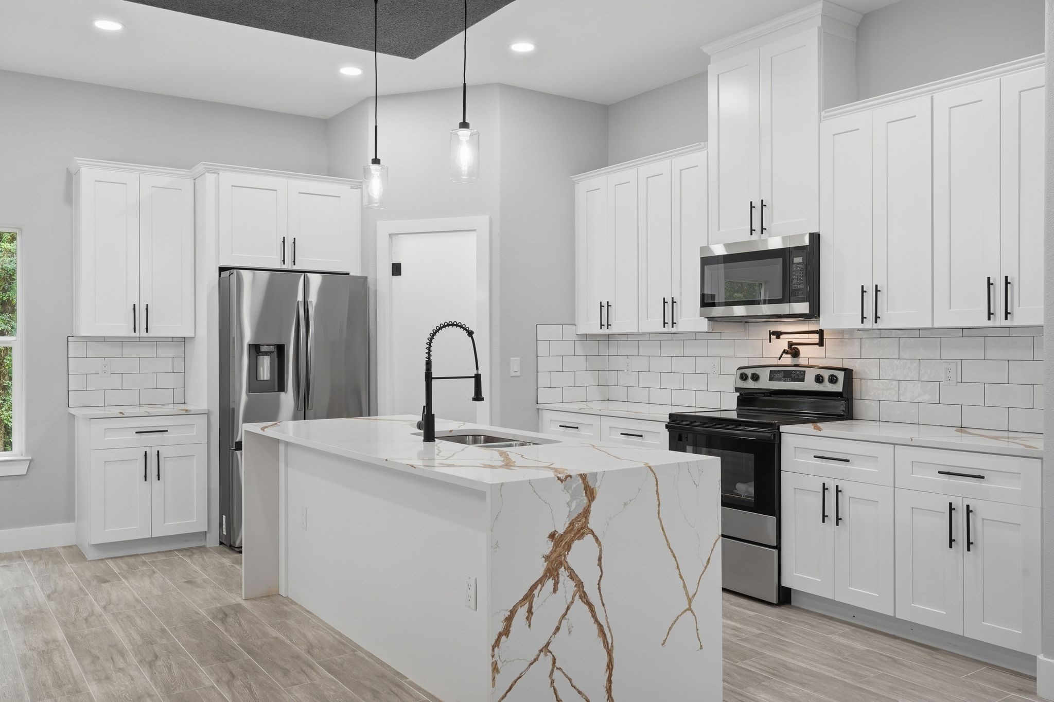 3575 Roy Bean Road Willis, TX 77378 - Photo 16 of 40 a kitchen with stainless steel appliances a refrigerator stove microwave and cabinets