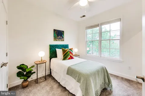 a bedroom with bed and a window
