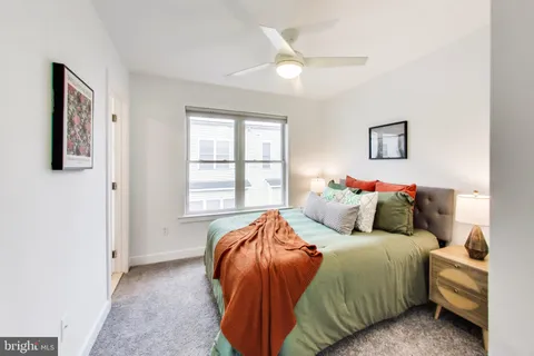 a bed sitting in a bedroom next to a window