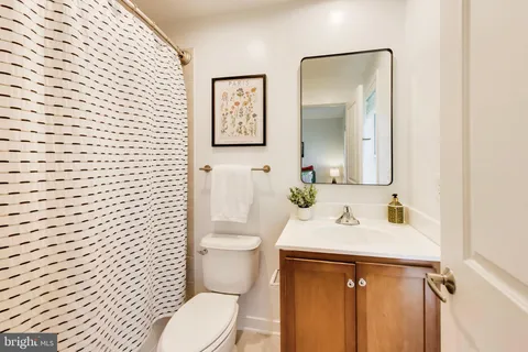 a bathroom with a toilet a sink and mirror