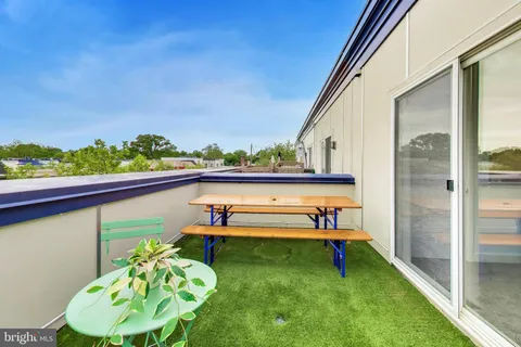 a balcony with table and chairs