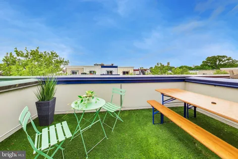 a view of a chairs and table in patio