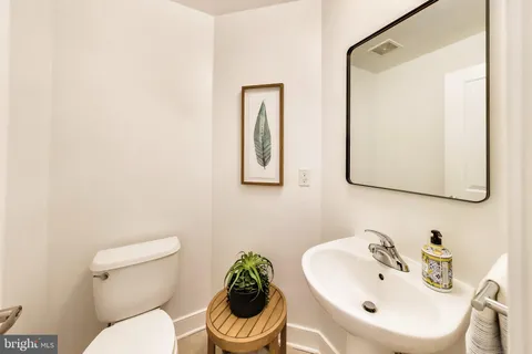 a bathroom with a sink mirror and toilet