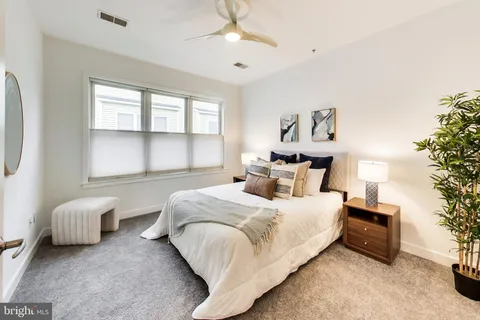 a bedroom with bed and window