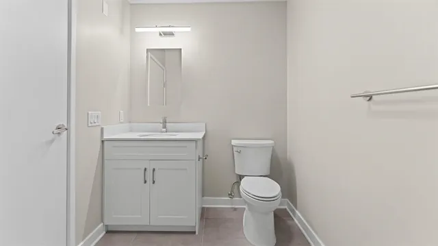a bathroom with a toilet sink and a mirror