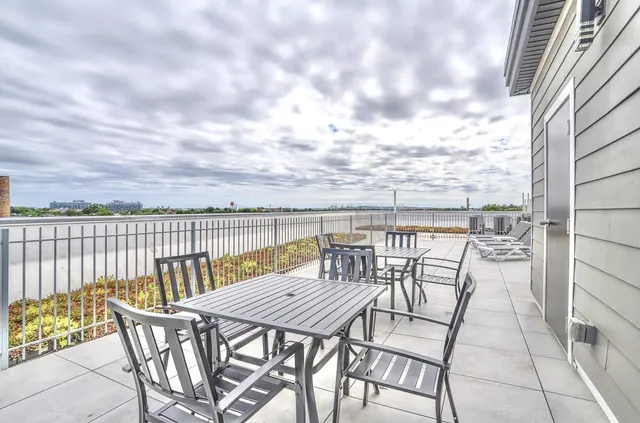 a view of a balcony with furniture