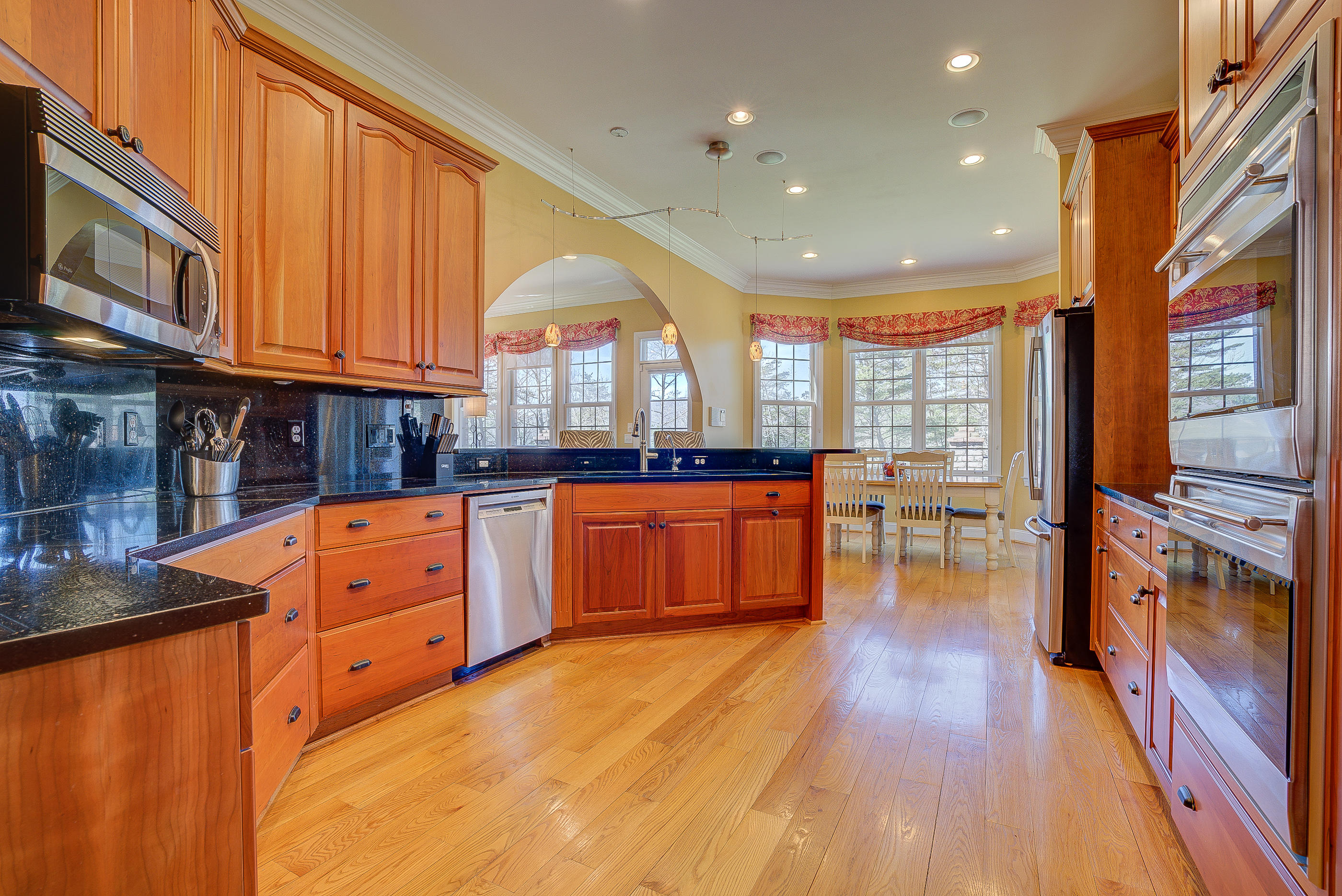 2851 New Ridge Road Elliston, VA 24087 - Photo 3 of 58 a kitchen with stainless steel appliances granite countertop a stove a sink dishwasher a dining table and chairs with wooden floor