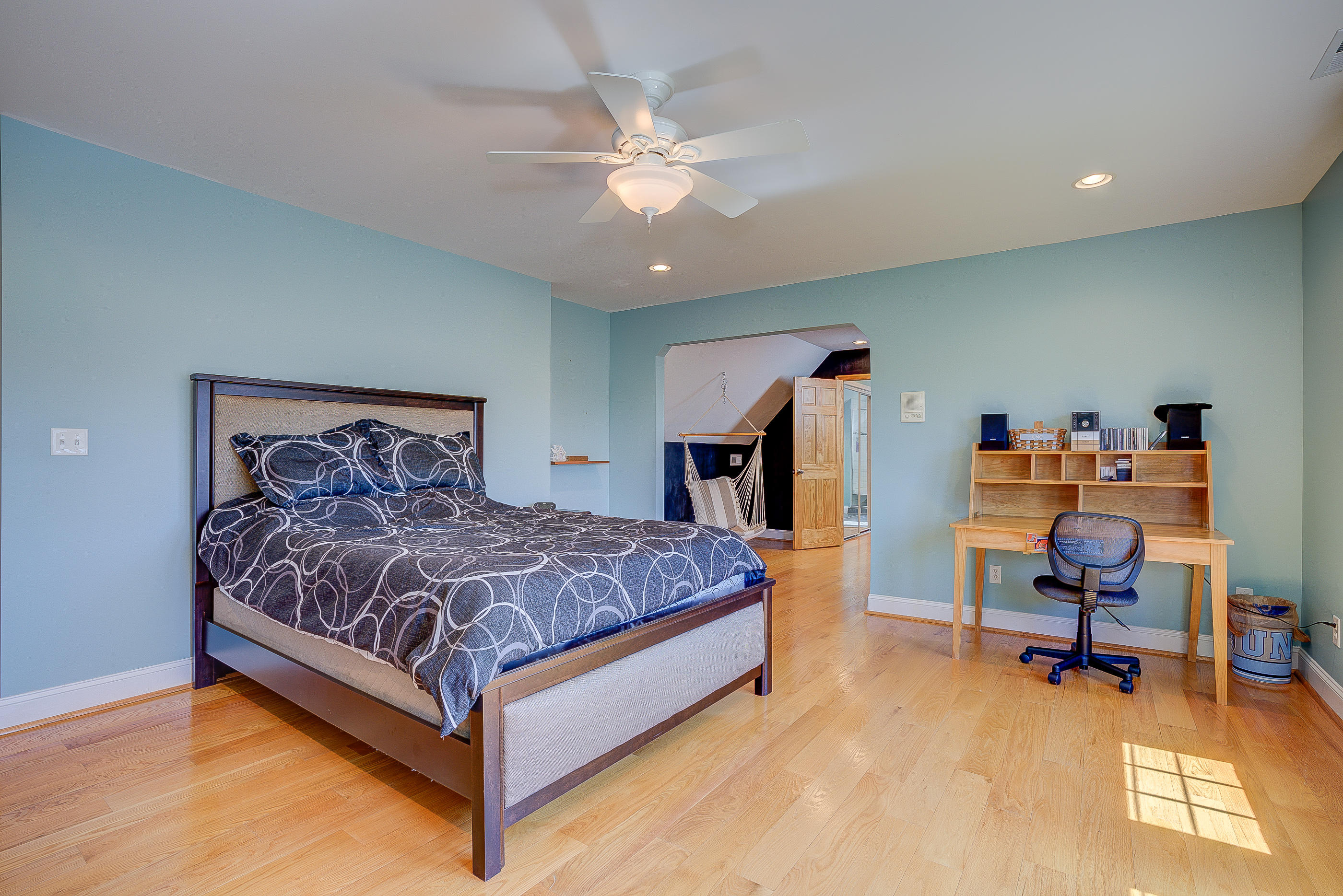 2851 New Ridge Road Elliston, VA 24087 - Photo 42 of 58 a spacious bedroom with a bed a table and a chandelier