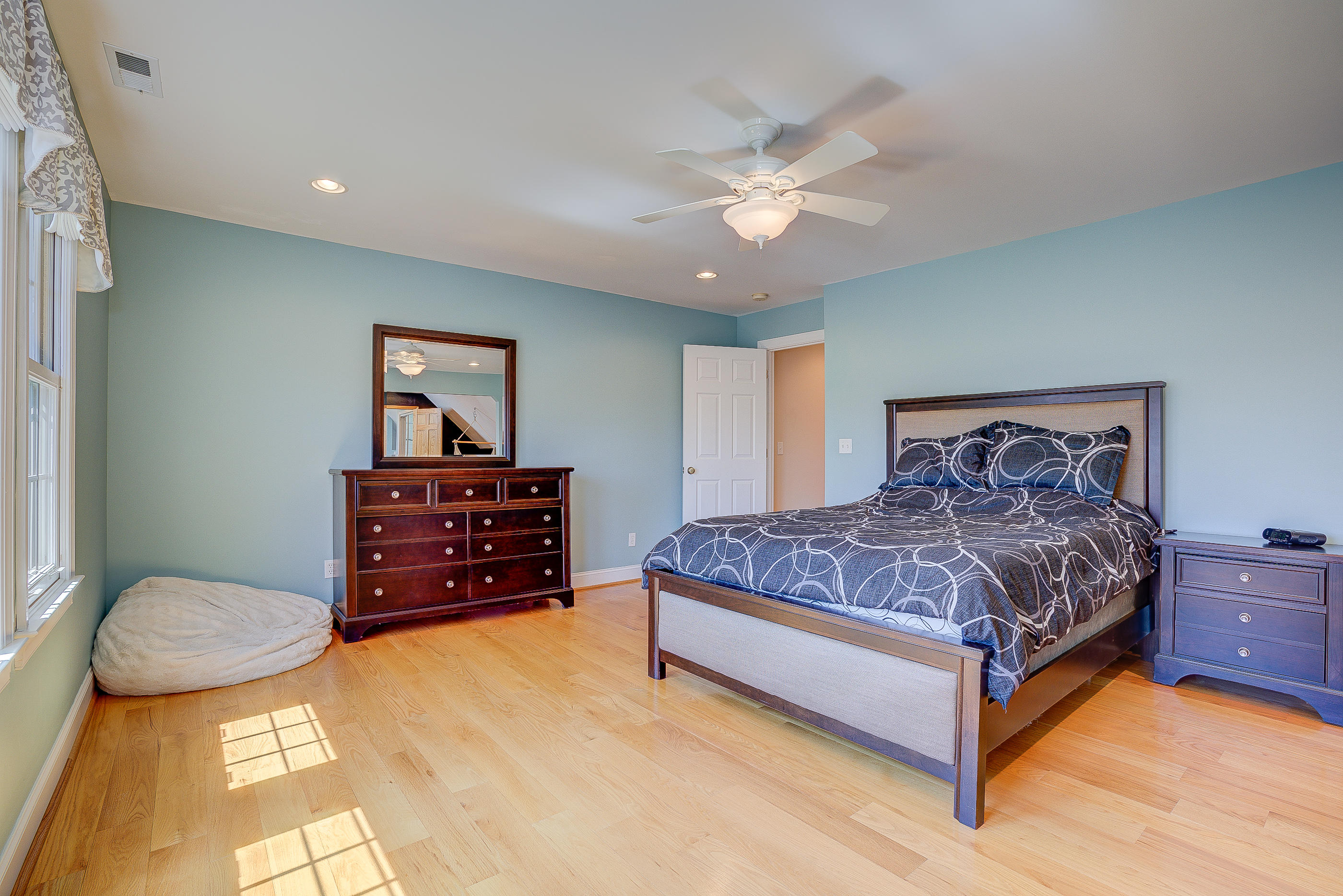 2851 New Ridge Road Elliston, VA 24087 - Photo 45 of 58 a spacious bedroom with a bed and a chandelier