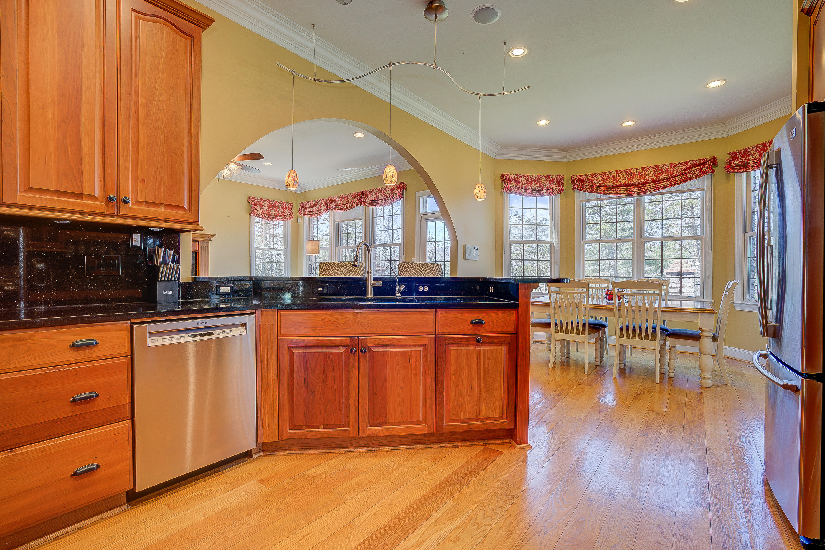 2851 New Ridge Road Elliston, VA 24087 - Photo 6 of 58 a large kitchen with stainless steel appliances granite countertop a stove a sink dishwasher and a dining table with wooden cabinet