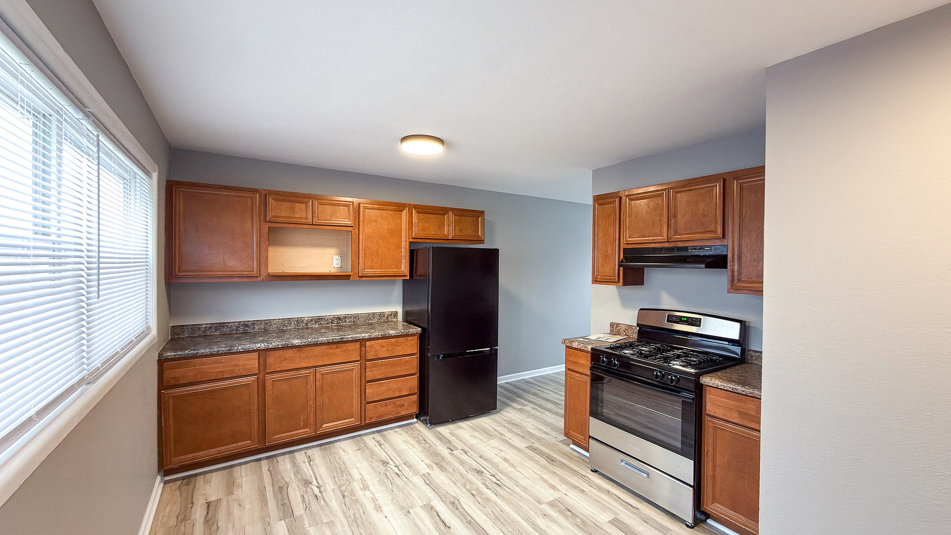 1703 Hedge Road Champaign, IL 61821 - Photo 4 of 17 a kitchen with stainless steel appliances granite countertop a stove a sink and a refrigerator
