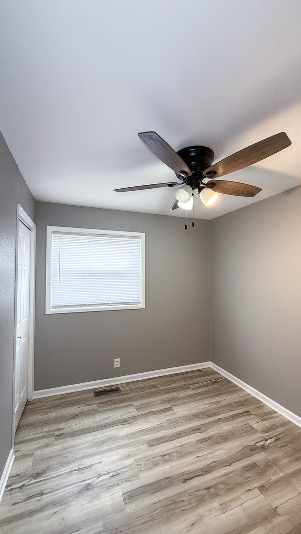 1703 Hedge Road Champaign, IL 61821 - Photo 9 of 17 a view of a room with wooden floor and fan