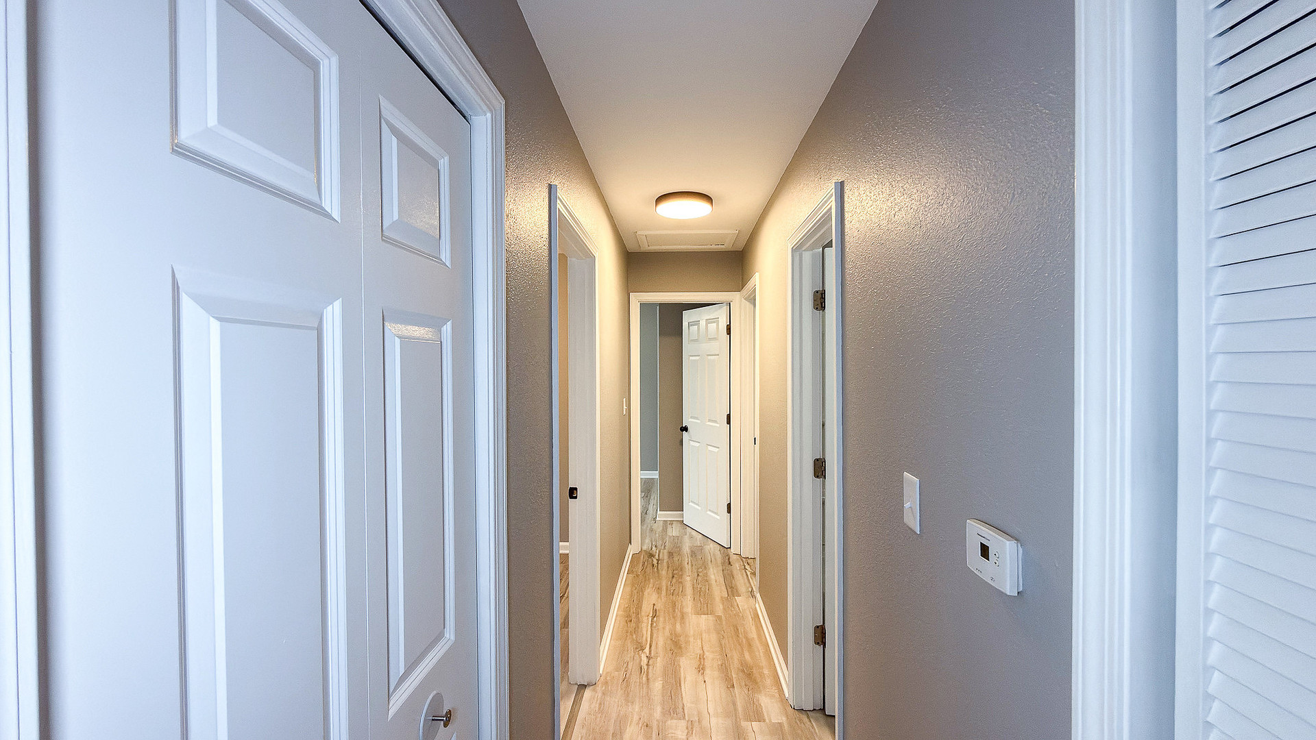 1703 Hedge Road Champaign, IL 61821 - Photo 10 of 17 a view of a hallway with wooden floor and a bathroom