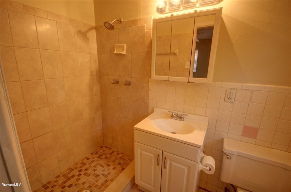 1312 Moss Lane Cocoa, FL 32922 - Photo 12 of 24 a bathroom with a sink a toilet and shower
