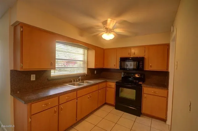 a kitchen with a sink cabinets and appliances