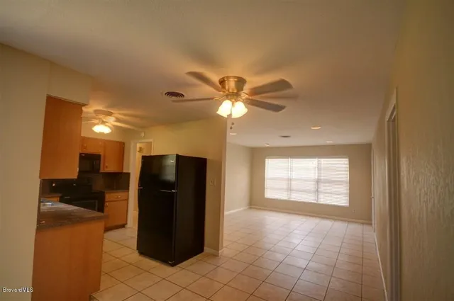 a view of a livingroom with a furniture and chandelier fan