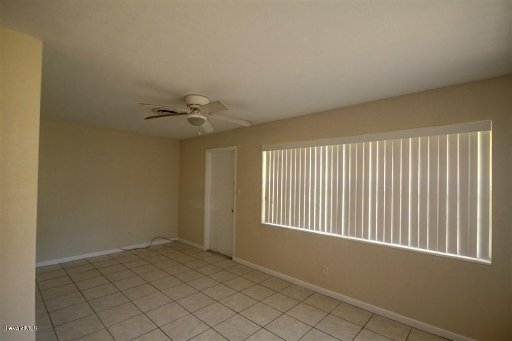 1312 Moss Lane Cocoa, FL 32922 - Photo 21 of 24 an empty room with a ceiling fan and window