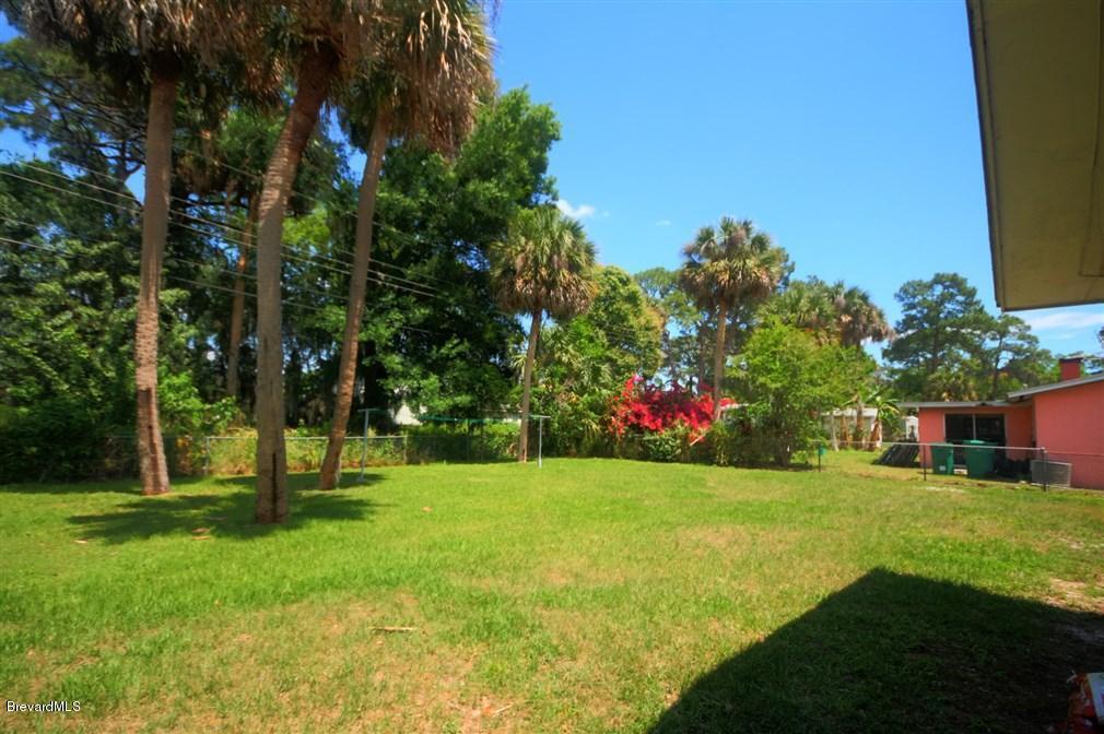 1312 Moss Lane Cocoa, FL 32922 - Photo 23 of 24 a view of an house with backyard space and garden