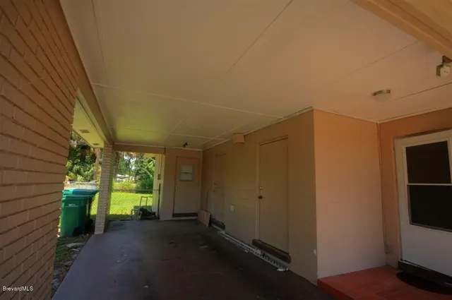 a view of a room with a large window and an outdoor space