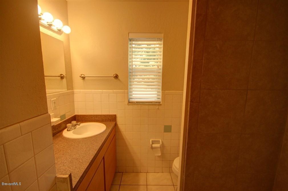 1312 Moss Lane Cocoa, FL 32922 - Photo 9 of 24 a bathroom with a sink and a mirror