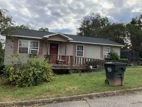 a view of a house with a backyard and sitting area