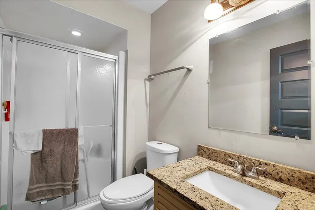 a bathroom with a sink toilet and shower