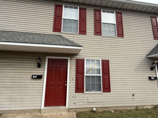 a view of a house with more windows and brick walls