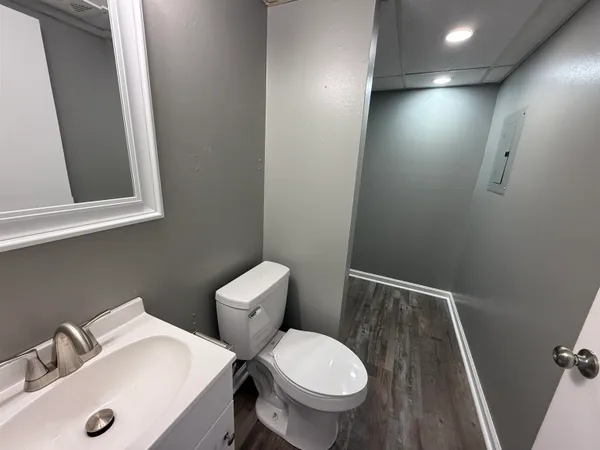 a bathroom with a toilet sink and mirror