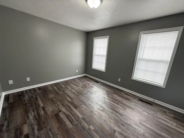 a view of room with window and hardwood floor