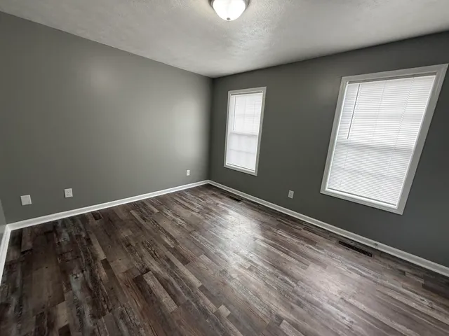 a view of room with window and hardwood floor
