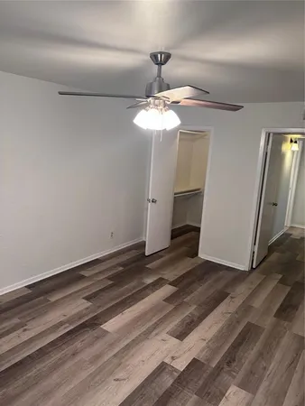 a view of a chandelier fan and wooden floor